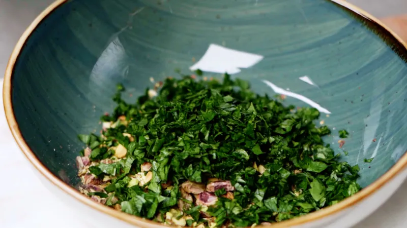 Add fresh chopped parsley to the pistachios