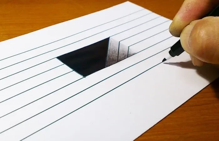 anamorphose de lignes noirs sur feuille blanche et fond couleur bois