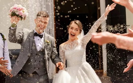 couple joyeux fraichement marie le jour de son mariage sous une pluie de riz