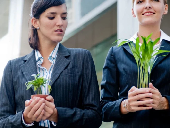 evitez de vous comparer aux autres avec deux femmes qui tiennent dans leurs mains un pot avec une plante verte chacune
