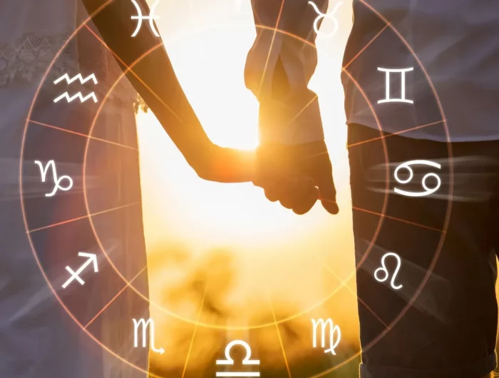 le zodiac sur un fond du soleil qui brille et un couple main dans la main