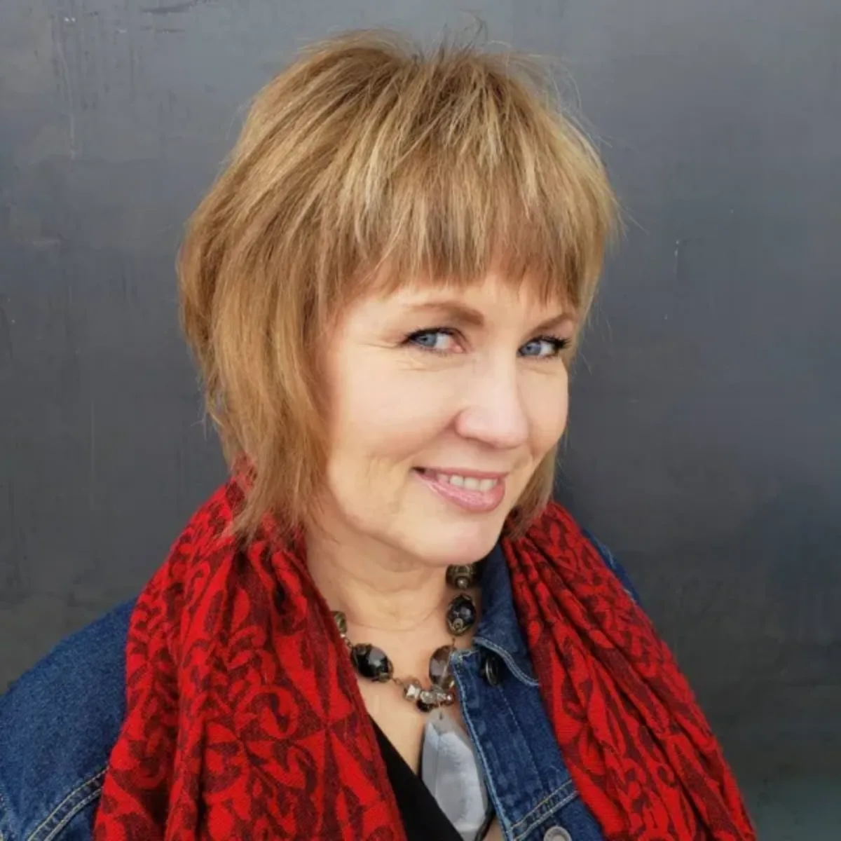 60 year old woman haircut model with bangs and blonde highlights