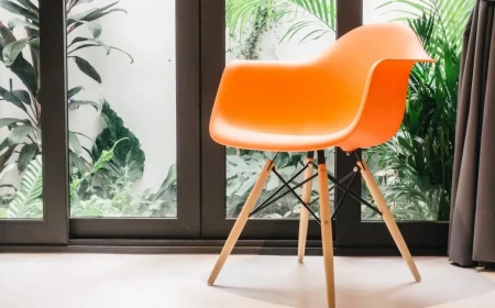 plantes vertes fenetres rideaux gris fonce chaise orange plastique pieds bois