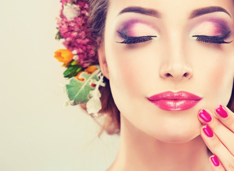 girl with delicate flowers in hair and fashion fuchsia nail