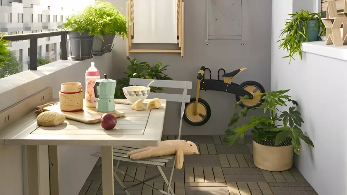 balcon avec des plantes une table une chaise et de la nourriture et un petit velo sans pedales au fond