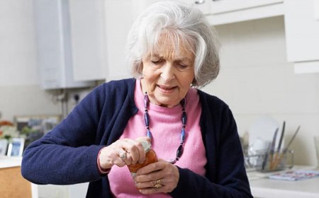 senior woman struggling to take lid off jar
