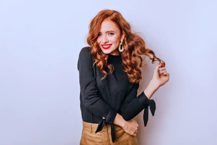 fashionable curly woman golden earrings standing white wall adorable stylish girl laughing