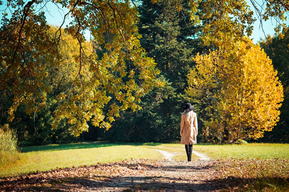 femme qui se promene sur une allee en automne
