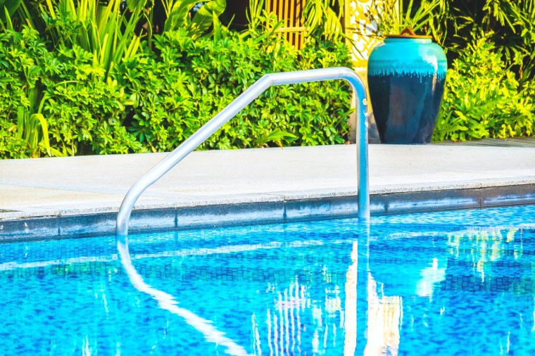 beautiful outdoor swimming pool with bed deck chair and umbrella