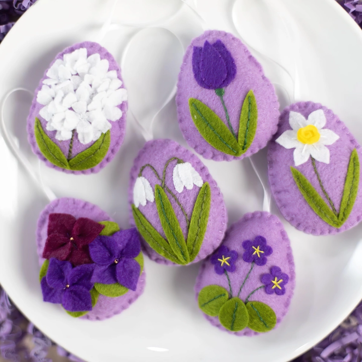 creation paques oeufs colores en feutre violet avec motifs fleurs brodes