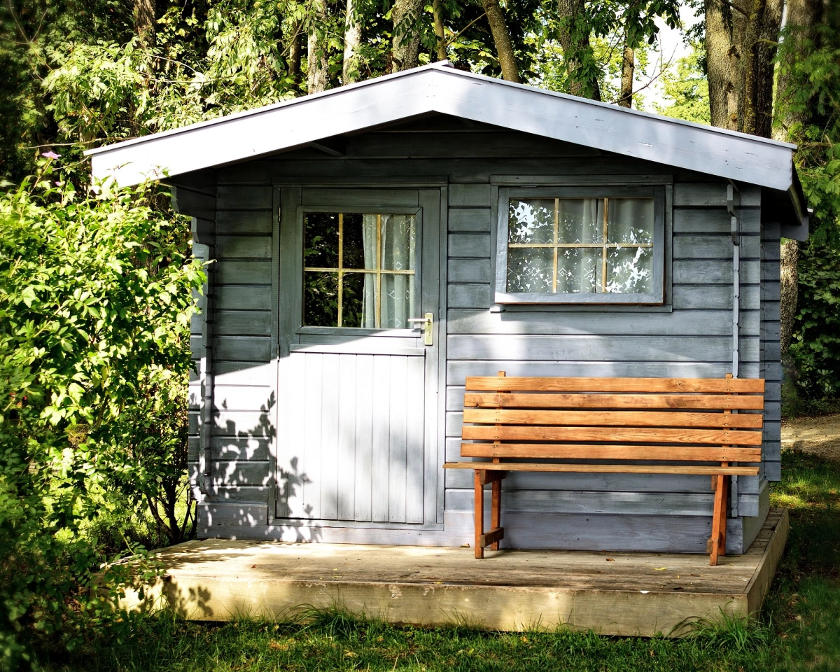 abri jardin en bois peint gris toiture fenetre porte banquette bois