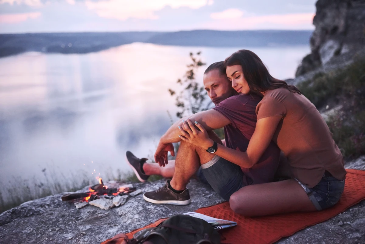 activite de couple exterieur feu devant un lac paysage montagne